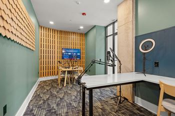 A room with a desk, chair, and a computer monitor.